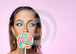 Beauty fashion model girl wiht colourful lollipop. Beautiful young woman portrait