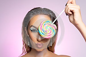 Beauty fashion model girl wiht colourful lollipop. Beautiful young woman portrait