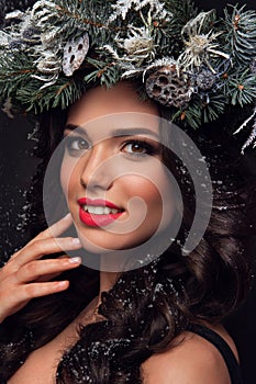 Beauty Fashion Model over Holiday. Beautiful girl with winter wreath.