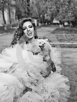 Beauty fashion model portrait. Glamour woman with dog