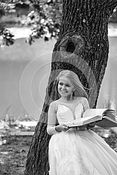 Beauty fashion model portrait. small girl in white dress outdoor