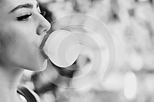 Beauty fashion model portrait. Woman with chewing gum bubble