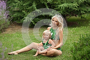 Beauty fashion mother with daughter family look. Beautiful blond