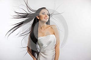 Beauty fashion photo of young beautiful girl in a flying white cloth.