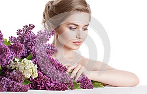 Beauty fashion portrait of a young woman with a huge bouquet of flowers