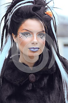 Beauty fashion punk teen girl portrait with art makeup and rock