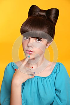 Beauty fashion teen girl with bow hairstyle and colourful manicu