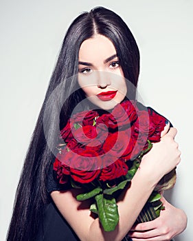 Beauty fashion woman with big bouquet of red roses