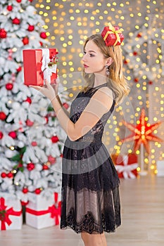 Beauty fashion woman Christmas background new year tree. Vogue style girl. Gorgeous female in luxury dress at Xmas