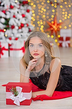 Beauty fashion woman Christmas background new year tree. Vogue style girl. Gorgeous female in luxury dress at Xmas