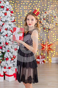 Beauty fashion woman Christmas background new year tree. Vogue style girl. Gorgeous female in luxury dress at Xmas