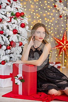 Beauty fashion woman Christmas background new year tree. Vogue style girl. Gorgeous female in luxury dress at Xmas