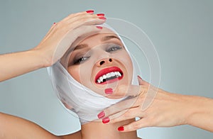 Beauty and Fashion. Woman after plastic surgery with bandaged face.