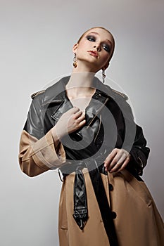 Beauty fashion young woman in trench coat, professional face makeup girl. Portrait of woman on white background. Spring clothing