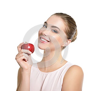 Beauty female portrait. Young attractive woman posing at studio with apple over white background. Beautiful girl with perfect