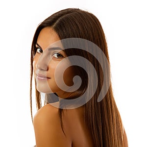 Beauty feminine portrait of female face with healthy natural skin. Beautiful tanned teen girl with long brown hair