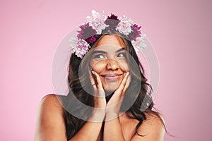 Beauty, flowers and crown on hair of woman in studio for cosmetics, skincare and wellness. Self care, spa treatment and