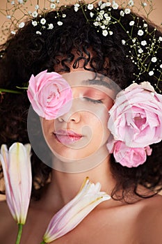 Beauty, flowers and face of woman relax with makeup, cosmetics and hair care for wellness, glamour and glow. Spring