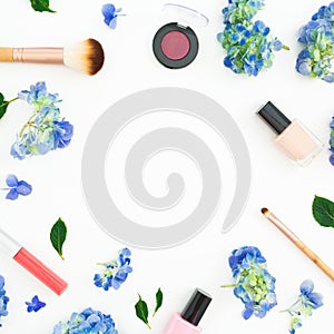 Beauty frame composition of hydrangea flowers with cosmetics on white background. Flat lay, top view