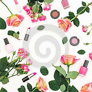 Beauty frame composition with roses flowers and feminine make up cosmetics on white background. Flat lay, top view.