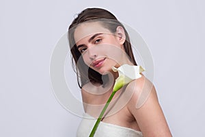 Beauty girl with calla lily. Beautiful sensual woman hold flowers, studio portrait.