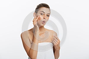 Beauty girl of caucasian woman checks her skin, skin care, acne treatment.