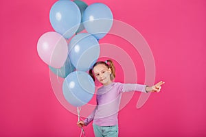 Beauty girl with colorful air balloons laughing over pink background. Beautiful Happy Young woman on birthday holiday party.