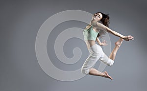 Beauty girl dance on grey background