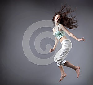Beauty girl dance on grey background