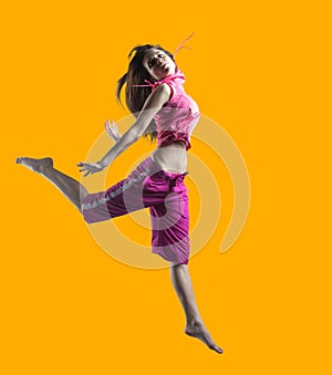 beauty girl dance on orange background. person jumping, flying in the air