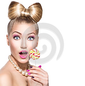 Beauty girl eating colourful lollipop