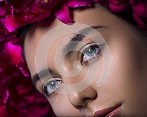 Beauty Girl face with Perfect Makeup. Beautiful young woman in red peony flowers wreath, Professional Make-up
