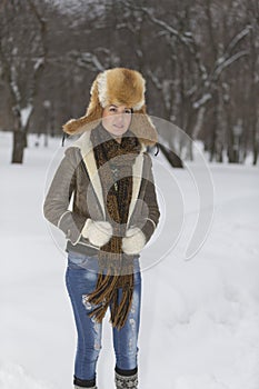 Beauty Girl in frosty winter Park. Outdoors. Flying Snowflakes.