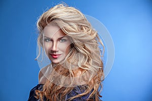 Beauty girl gorgeous hair portrait on a blue background in denim