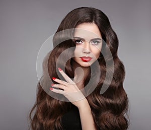 Beauty girl hair. Red lips and manicured nails. Beautiful model