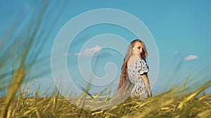 Beauty Girl with Healthy Long Hair Outdoors. Happy Smiling Young Woman falling down on the grass.