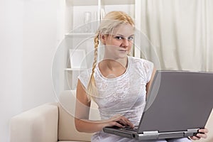 Beauty girl with laptop in room