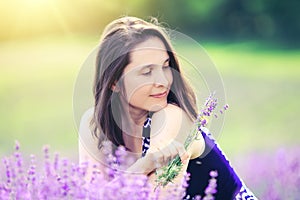 Beauty girl in lavender field. Happy woman on meadow backgrou