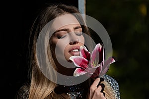 Beauty girl with lily. Beautiful sensual woman flowers, studio close up portrait.