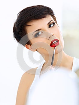 Beauty Girl with Makeup Brush. Natural Make-up for Brunette Woman with Red Lips