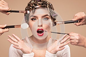 Beauty girl with makeup brushes around