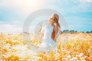 Beauty girl outdoors enjoying nature. Beautiful teenage model girl with healthy long hair in white dress