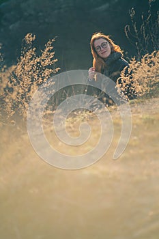Beauty Girl Outdoors enjoying nature. Beautiful Teenage Model girl with long healthy blowing hair running on the Spring Field, Sun
