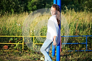 Beauty Girl Outdoors enjoying nature. Teenage Model girl running on the Spring Field, Sun Light.