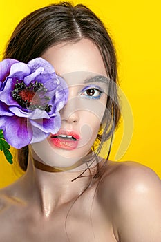 Beauty Girl Portrait with Vivid Makeup. Fashion Woman portrait close up on yellow background. Bright Colors. Manicure Make up. Smo