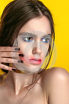 Beauty Girl Portrait with Vivid Makeup. Fashion Woman portrait close up on yellow background. Bright Colors. Manicure Make up. Smo