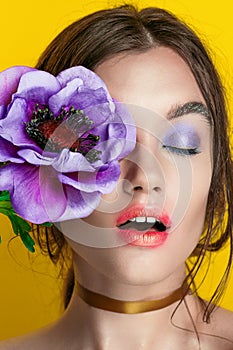 Beauty Girl Portrait with Vivid Makeup. Fashion Woman portrait close up on yellow background. Bright Colors. Manicure Make up. Smo