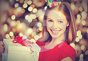 Beauty girl in red dress with gift box to birthday or Valentine's Day