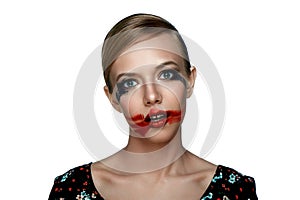 Beauty Girl with smeared red Lipstick on open Mouth.