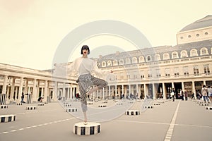 Beauty girl stand in yoga pose in paris, france. Beauty model pose in high heel shoes on column